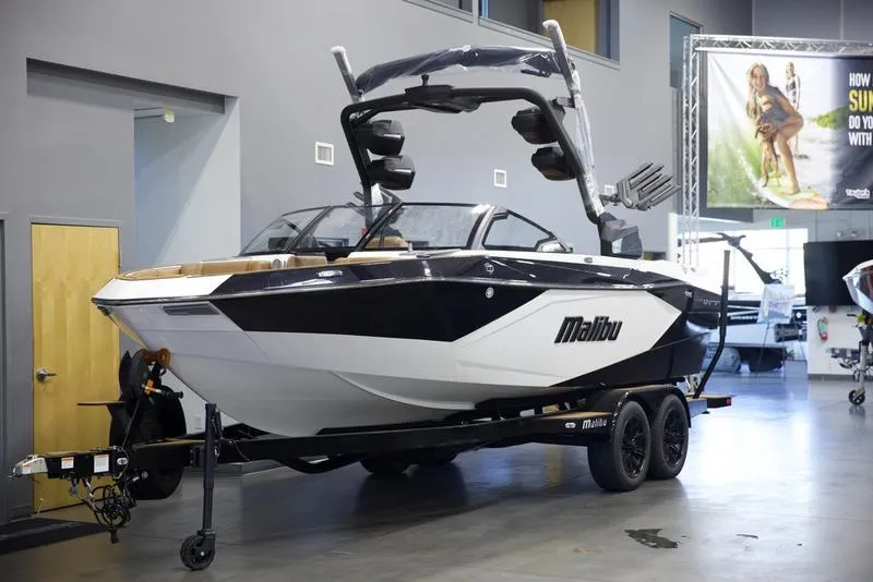 Slide: The Image of 2025 Malibu 23 LSV boat on trailer in showroom. - 3