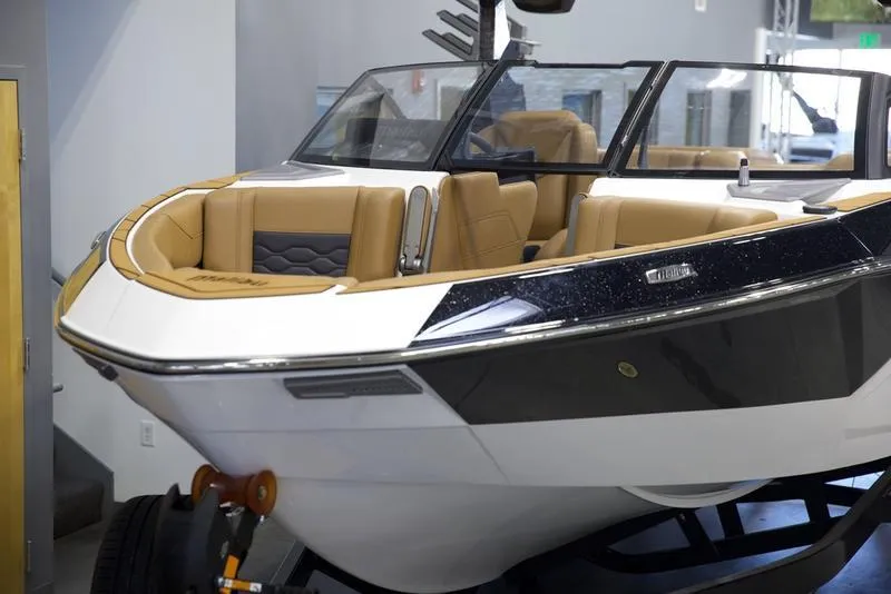Slide: The Image of 2025 Malibu 23 LSV boat with sleek design and tan interior. - 8