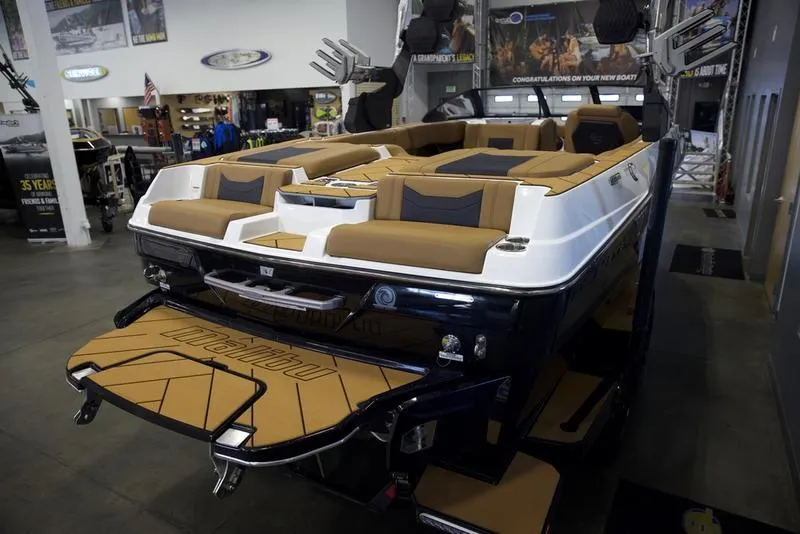 Slide: The Image of 2025 Malibu 23 LSV boat with luxurious seating in showroom. - 9