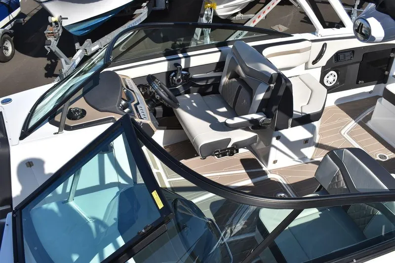 Slide: The Image of 2023 Monterey 255SS boat interior with sleek seating and modern dashboard design. - 21