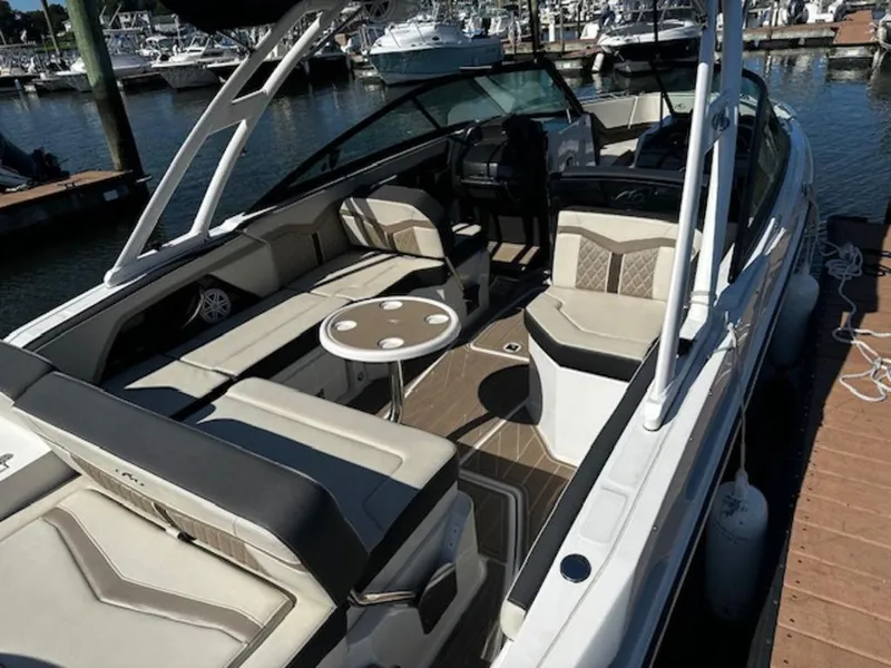 Slide: The Image of 2023 Monterey 255SS boat interior with seating and table, docked at marina. - 4