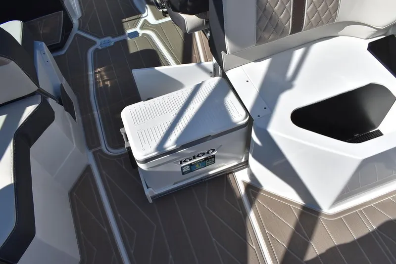 Slide: The Image of 2023 Monterey 255SS boat interior with Igloo cooler and seating area. - 45