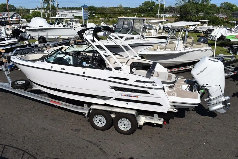 Slide: The Image of 2023 Monterey 255SS boat on trailer in marina setting. - 8