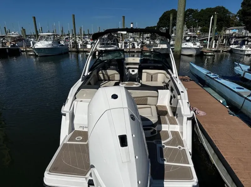 Slide: The Image of 2023 Monterey 255SS boat docked at marina, featuring spacious seating and sleek design. - 9