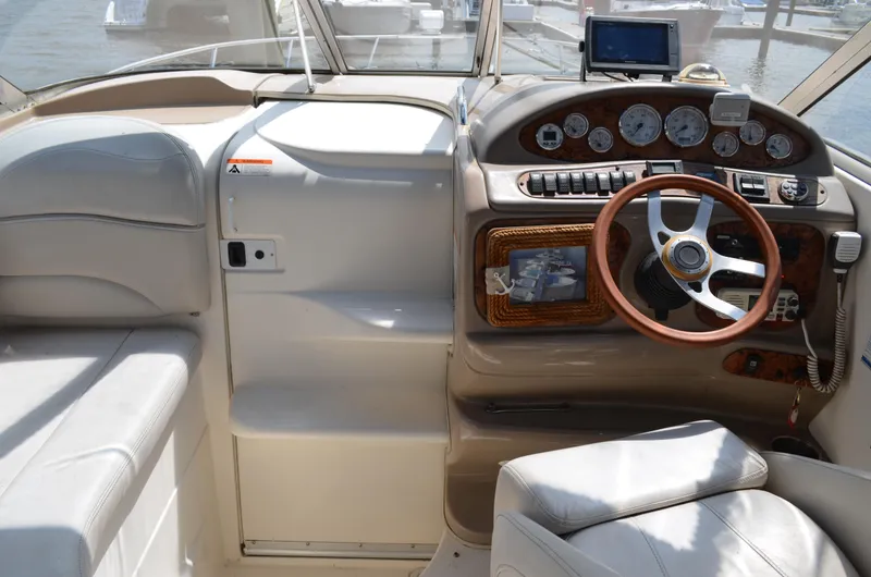 Slide: The Image of 2006 Larson Cabrio 240 boat cockpit with steering wheel and control panel. - 17