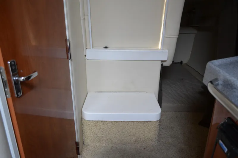 Slide: The Image of 2006 Larson Cabrio 240 interior with beige walls and compact step. - 28