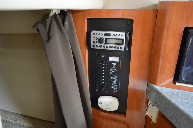 Slide: The Image of 2006 Larson Cabrio 240 cabin control panel with radio and electrical switches. - 29