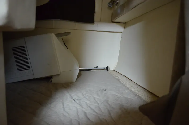 Slide: The Image of Interior cabin view of a 2006 Larson Cabrio 240 boat, showing storage space. - 30