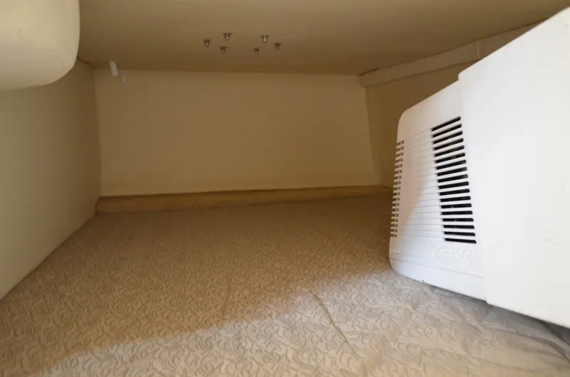 Slide: The Image of 2006 Larson Cabrio 240 interior cabin with patterned flooring and white appliance. - 31