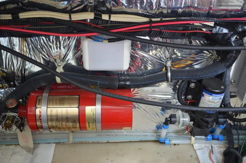 Slide: The Image of Engine compartment of a 2006 Larson Cabrio 240 with fire extinguisher and wiring. - 35