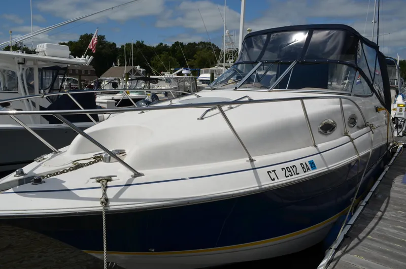Slide: The Image of 2006 Larson Cabrio 240 boat docked at marina under clear sky. - 5