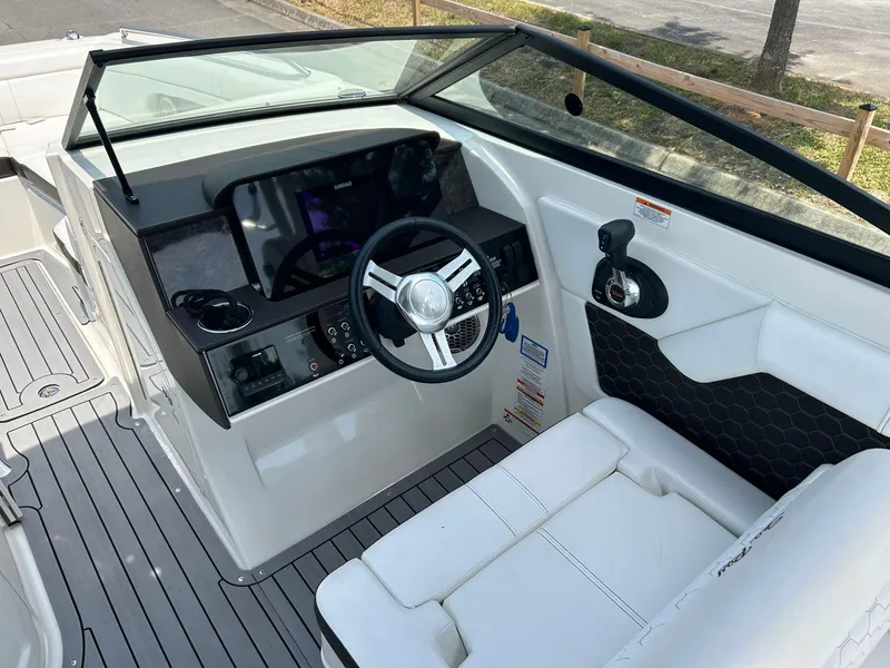 Slide: The Image of 2019 Sea Ray 270 SDX boat cockpit with steering wheel and control panel. - 11