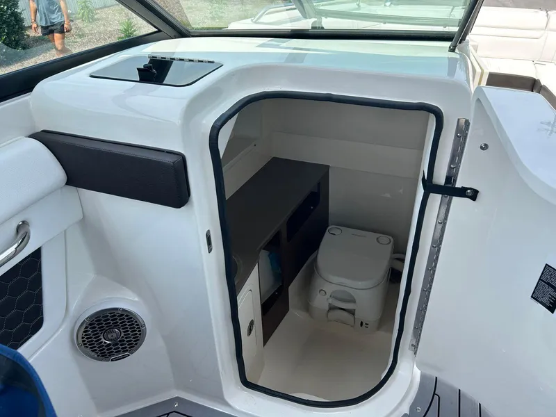 Slide: The Image of 2019 Sea Ray 270 SDX boat interior with compact marine toilet. - 13