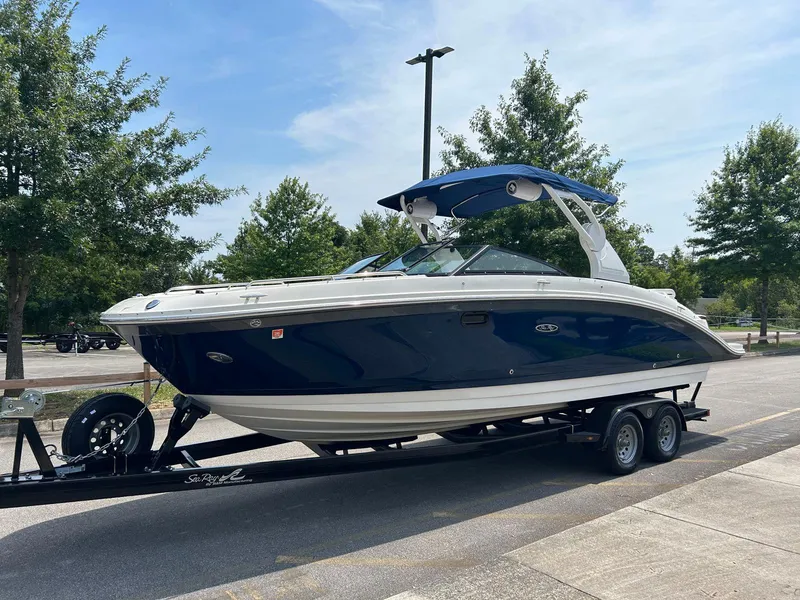 Slide: The Image of 2019 Sea Ray 270 SDX boat on trailer in parking lot. - 2