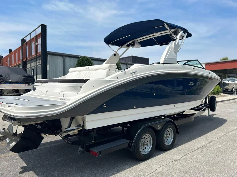 Slide: The Image of 2019 Sea Ray 270 SDX boat on trailer, blue and white exterior, parked outdoors. - 5