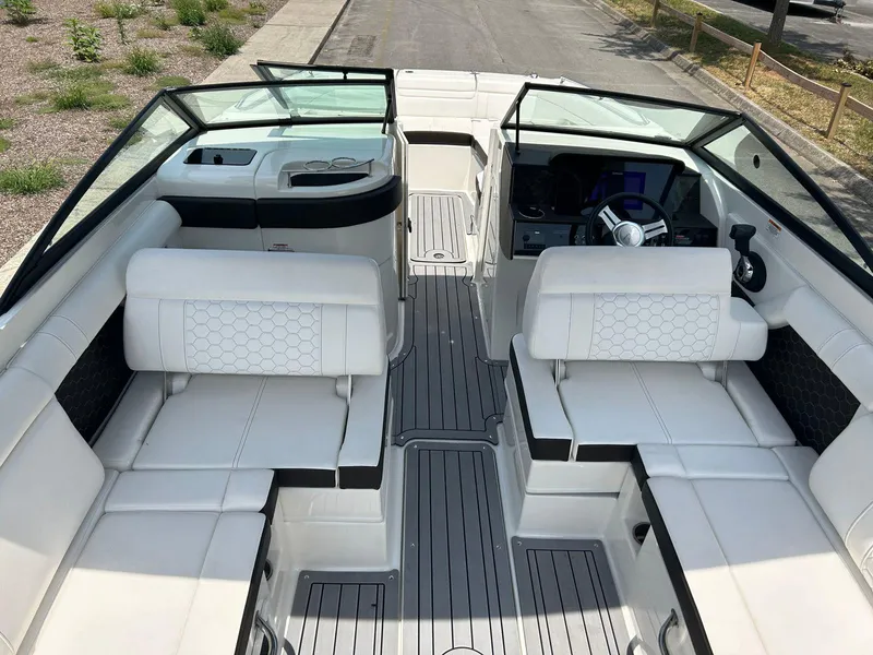 Slide: The Image of 2019 Sea Ray 270 SDX boat interior with white seating and modern dashboard. - 8