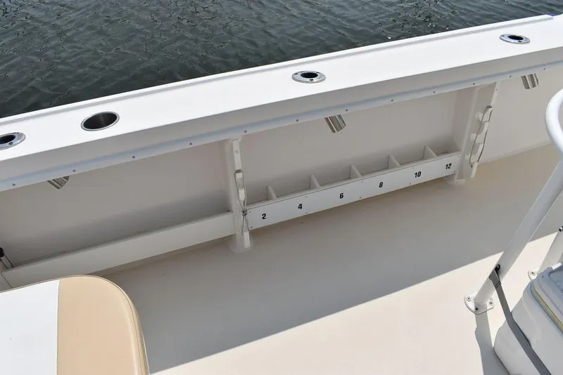 Slide: The Image of 2015 Steiger Craft 255 Center Console boat interior with rod holders and storage compartments. - 15