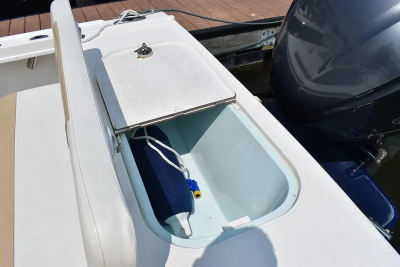 Slide: The Image of Open storage compartment on 2015 Steiger Craft 255 Center Console boat. - 17