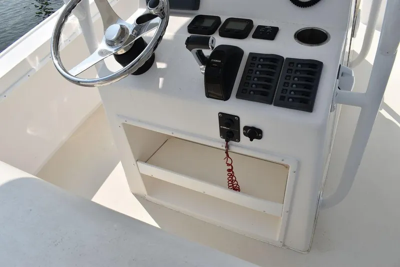 Slide: The Image of 2015 Steiger Craft 255 Center Console helm with steering wheel and controls. - 25