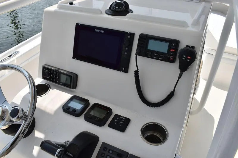 Slide: The Image of Steiger Craft 255 Center Console 2015 dashboard with navigation and communication equipment. - 28