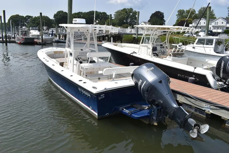 Slide: The Image of 2015 Steiger Craft 255 Center Console boat docked in marina. - 3