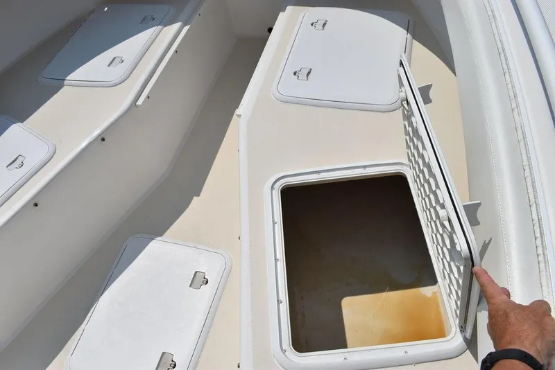Slide: The Image of 2015 Steiger Craft 255 Center Console storage compartments open on deck. - 46