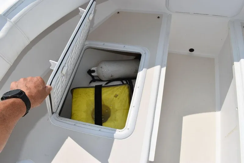 Slide: The Image of Open storage compartment on 2015 Steiger Craft 255 Center Console boat. - 48