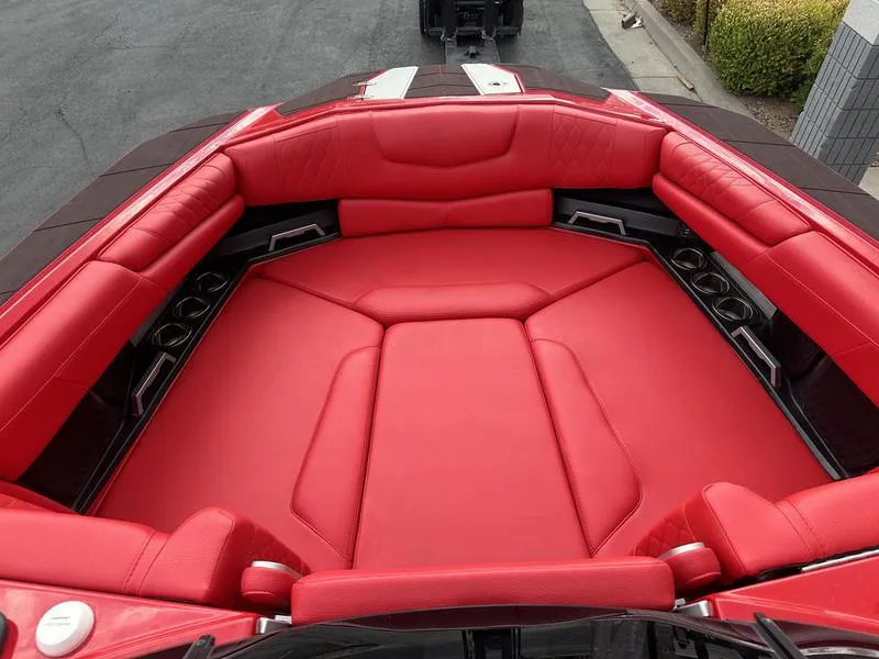 Slide: The Image of 2021 Malibu M240 boat with luxurious red interior seating. - 1