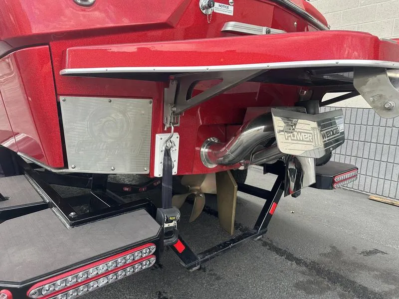 Slide: The Image of 2021 Malibu M240 boat rear view with propeller and exhaust system. - 12