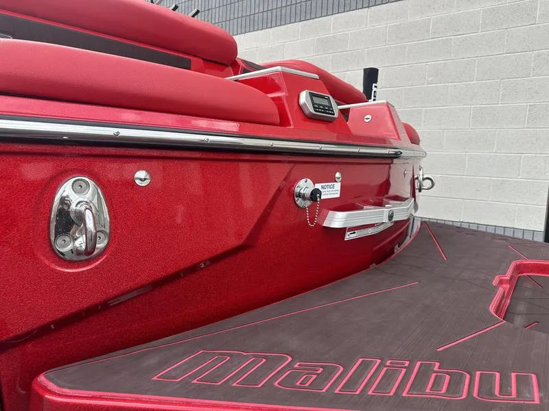 Slide: The Image of Red 2021 Malibu M240 boat with sleek design and branded deck. - 16