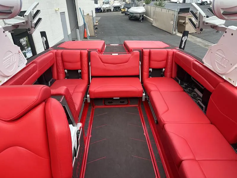 Slide: The Image of 2021 Malibu M240 boat with vibrant red interior seating. - 18