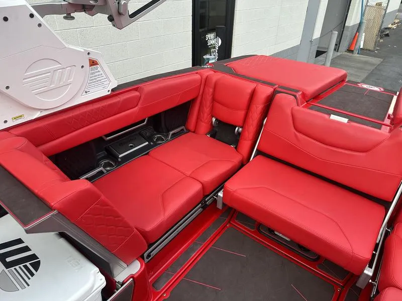 Slide: The Image of 2021 Malibu M240 boat with luxurious red seating and modern design. - 19