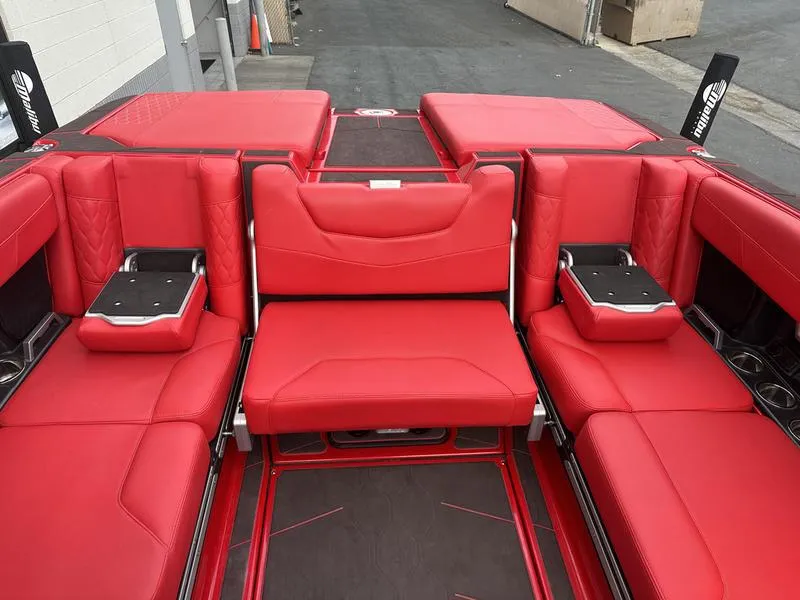 Slide: The Image of Red interior seating of 2021 Malibu M240 boat, featuring luxurious design and ample space. - 21