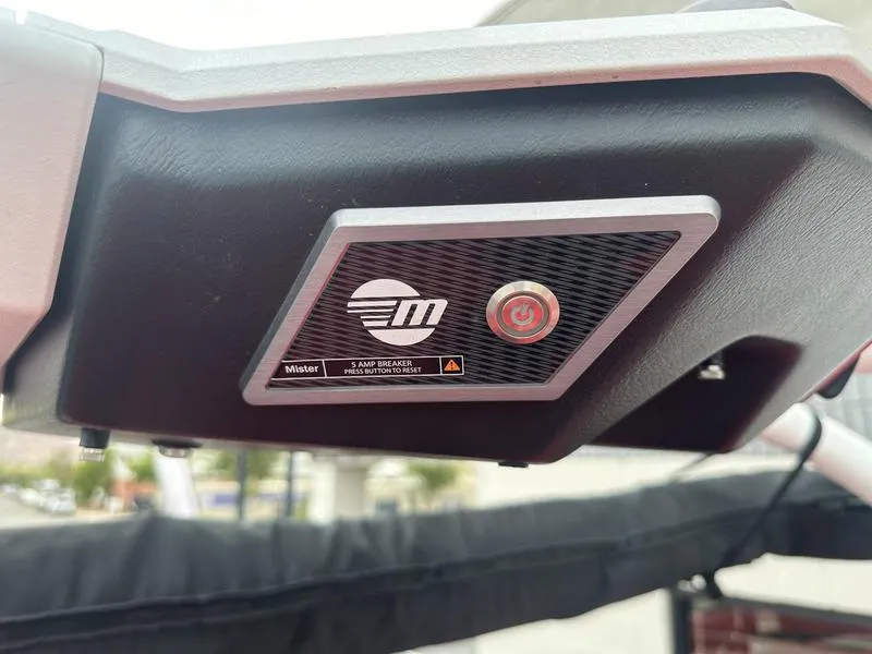 Slide: The Image of 2021 Malibu M240 boat dashboard with control panel and logo. - 28