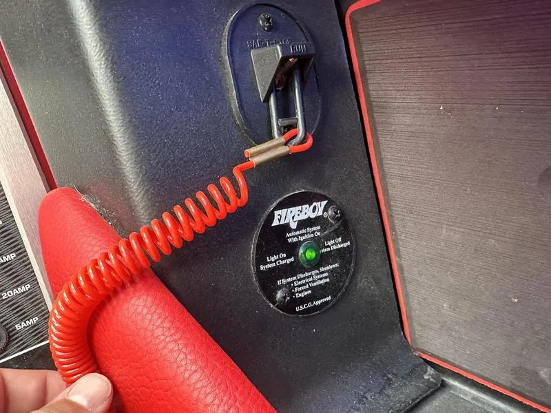 Slide: The Image of 2021 Malibu M240 safety system with Fireboy suppression device and red coiled cable. - 3