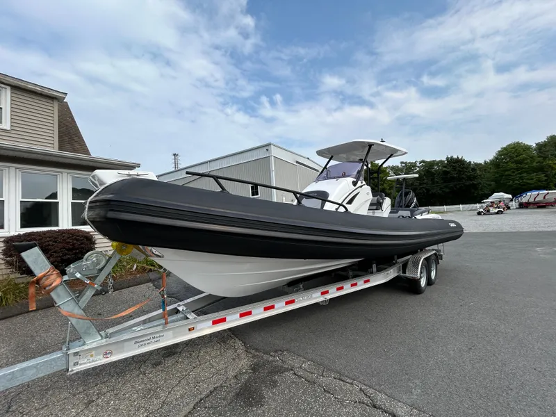 Slide: The Image of 2025 Grand Inflatables G850 boat on trailer, parked outdoors. - 10