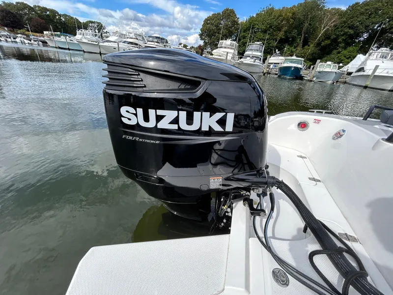 Slide: The Image of Suzuki outboard motor on 2025 Grand Inflatables G850 boat, docked in marina. - 12