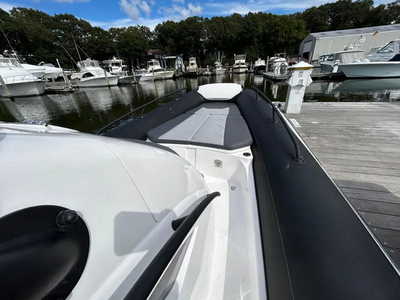 Slide: The Image of 2025 Grand Inflatables G850 boat docked at marina, featuring sleek design and spacious seating. - 22