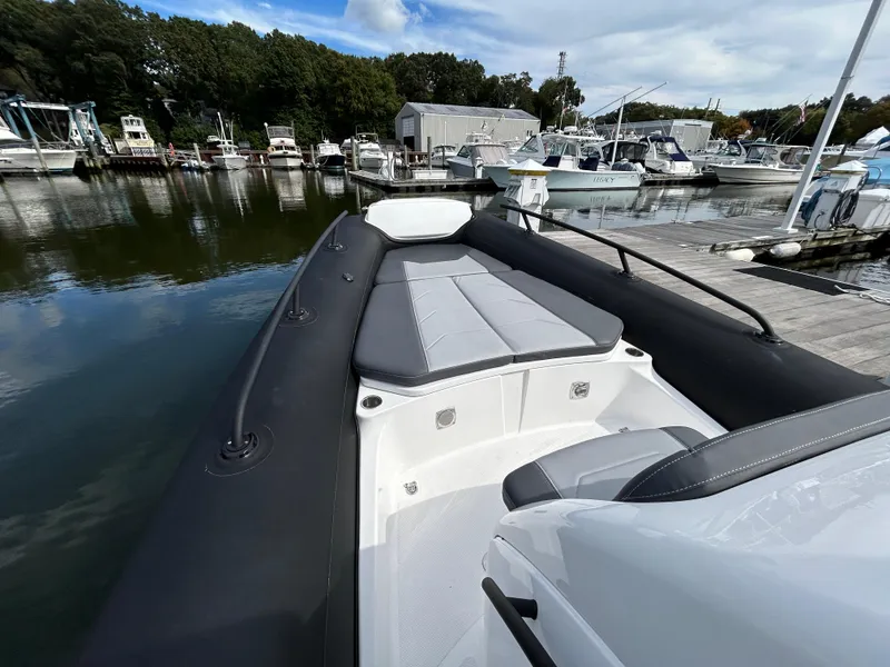 Slide: The Image of 2025 Grand Inflatables G850 boat docked at marina, featuring sleek design and spacious seating. - 26