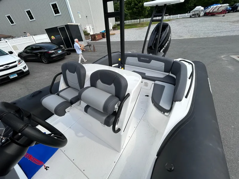 Slide: The Image of 2025 Grand Inflatables G850 boat interior with modern seating and steering wheel. - 37