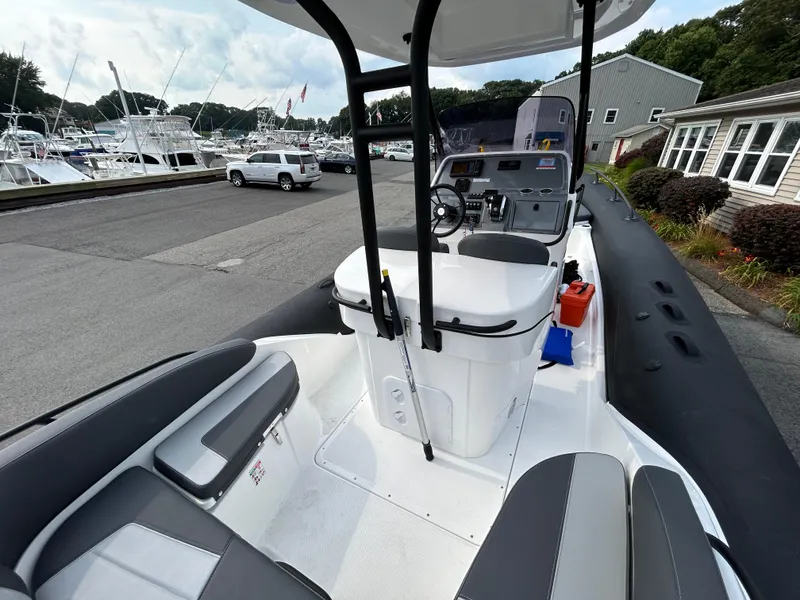 Slide: The Image of 2025 Grand Inflatables G850 boat interior at marina, featuring sleek seating and control console. - 38