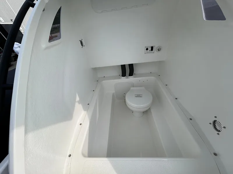 Slide: The Image of 2025 Grand Inflatables G850 boat interior with compact marine toilet. - 39