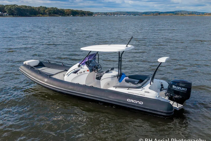 The Image of 2025 Grand Inflatables G850 boat on water, featuring Suzuki outboard motor. - 0