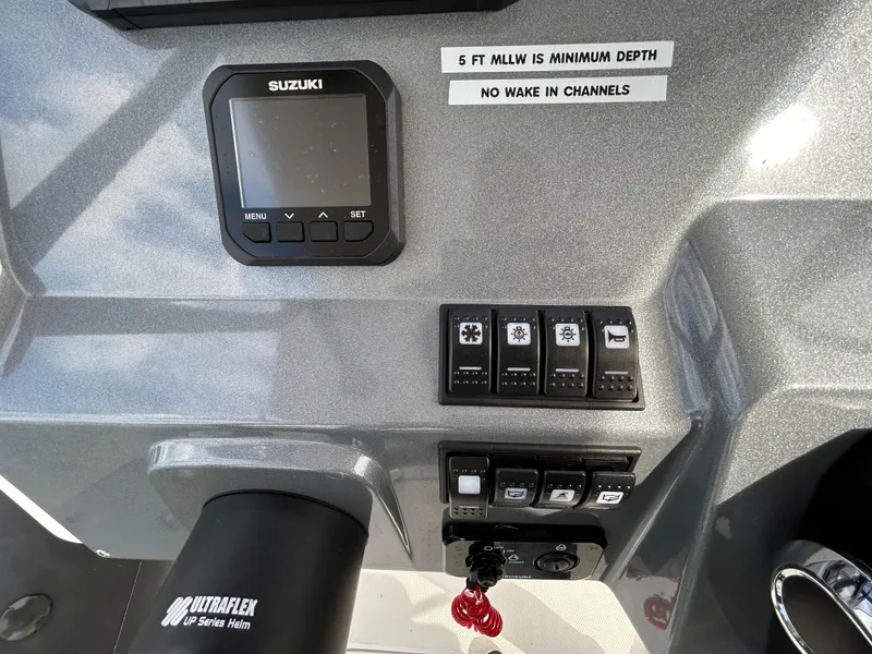 Slide: The Image of Control panel of 2025 Grand Inflatables G850 boat with Suzuki display and switches. - 17