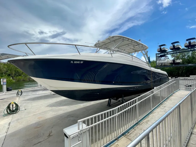 The Image of 2005 Hydra-Sports Vector 3300 VX boat on a dock under a cloudy sky. - 0