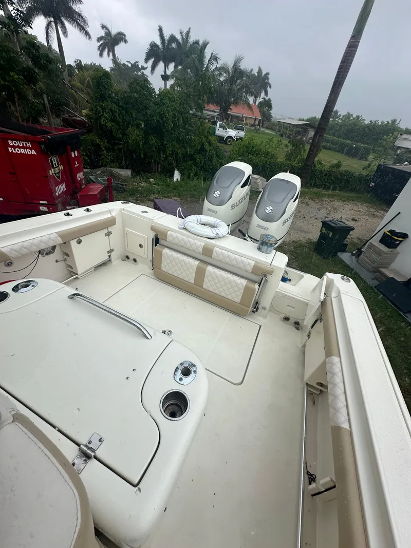 Slide: The Image of 2005 Hydra-Sports Vector 3300 VX boat with dual engines, docked near palm trees. - 22