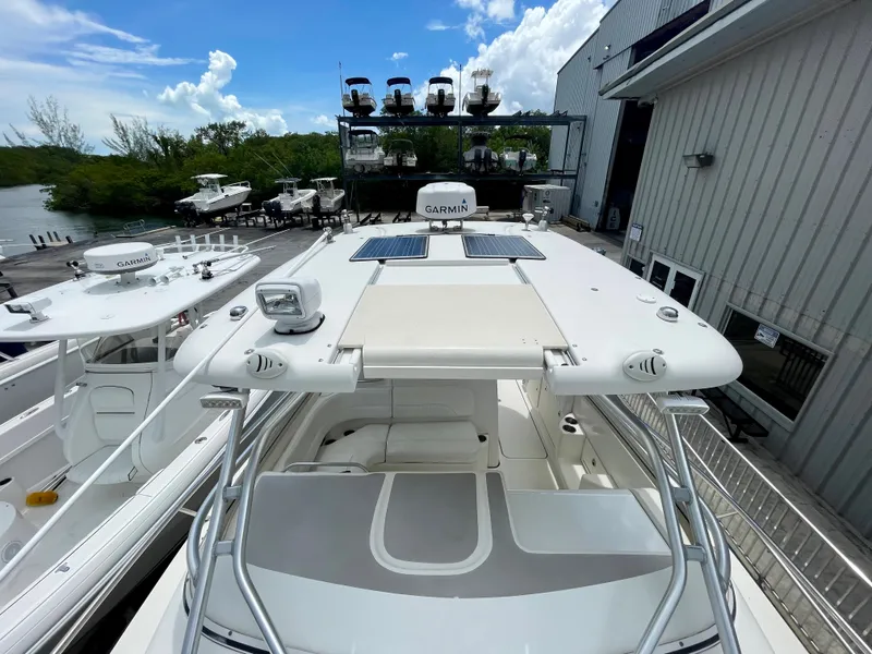 Slide: The Image of 2005 Hydra-Sports Vector 3300 VX boat docked near marina, clear sky background. - 4