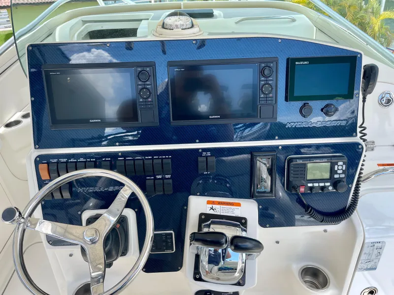Slide: The Image of 2005 Hydra-Sports Vector 3300 VX dashboard with navigation screens and controls. - 7