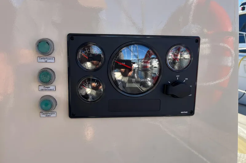 Slide: The Image of Control panel of a 2002 Puffin 42 boat with gauges and switches. - 100