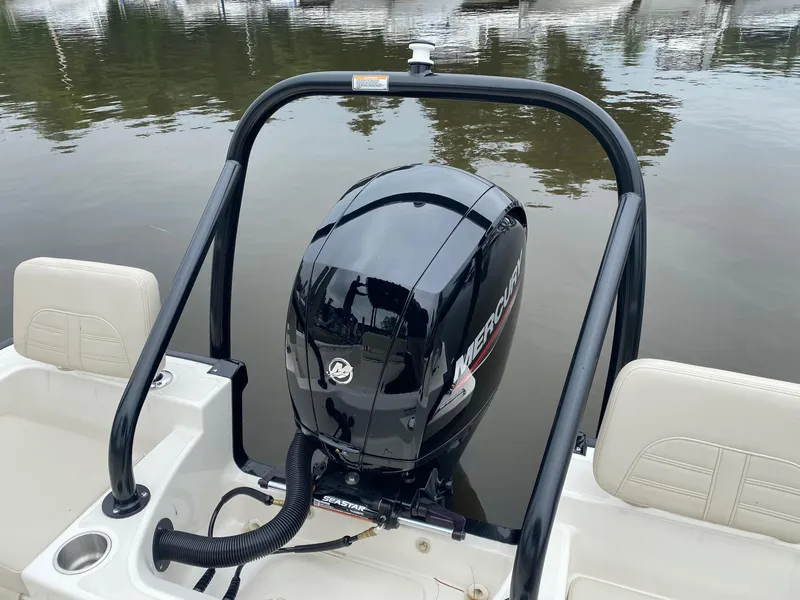 Slide: The Image of 2023 Boston Whaler 190 Montauk with Mercury outboard engine on calm water. - 11